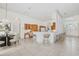 Kitchen and dining area with tile floor, breakfast bar with barstools, and bright natural light at 6083 Sabal Hammock Cir, Port Orange, FL 32128