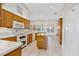 Kitchen with tile floors, wood cabinets, center island, and modern appliances at 6083 Sabal Hammock Cir, Port Orange, FL 32128