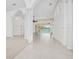 Spacious living area with tile floors, high ceilings, and sliding glass doors offering views of the pool at 6083 Sabal Hammock Cir, Port Orange, FL 32128