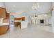 Open concept kitchen, living room with tile floor, arches, and fireplace; bright and spacious at 6083 Sabal Hammock Cir, Port Orange, FL 32128