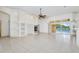 Living room with tile floor, fireplace, arches, built-in shelving, and sliding doors to the pool area at 6083 Sabal Hammock Cir, Port Orange, FL 32128