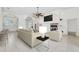 Staged open-plan living room with tile floor, arches, a fireplace, and chandelier-lit foyer with double doors at 6083 Sabal Hammock Cir, Port Orange, FL 32128