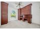 Office space with custom built-in cherry cabinets, desk, and a large window for natural light at 6083 Sabal Hammock Cir, Port Orange, FL 32128