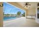 Relaxing screened-in pool area with an outdoor kitchen and scenic lake views, ideal for entertaining at 6083 Sabal Hammock Cir, Port Orange, FL 32128