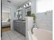 Bathroom showcasing a tub, tiled walls, and an entrance to an adjacent bedroom at 613 John Thomas Ave, Deland, FL 32724