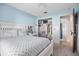 Cozy bedroom with a bed, closet space, and a view into the ensuite bathroom at 613 John Thomas Ave, Deland, FL 32724