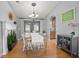 Open concept dining room features hardwood floors, accent fireplace, and access to backyard at 613 John Thomas Ave, Deland, FL 32724