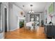 Well-lit dining room with hardwood floors, an accent fireplace, and a charming chandelier at 613 John Thomas Ave, Deland, FL 32724