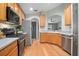 A kitchen with stainless steel appliances and hardwood floors at 613 John Thomas Ave, Deland, FL 32724