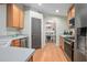 Functional kitchen featuring stainless steel appliances, hardwood floors, and ample countertop space at 613 John Thomas Ave, Deland, FL 32724