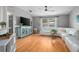 Cozy living room featuring hardwood floors, an entertainment center and a comfortable white sofa at 613 John Thomas Ave, Deland, FL 32724