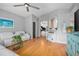 Inviting living room featuring light gray walls, hardwood floors, and a ceiling fan for added comfort and style at 613 John Thomas Ave, Deland, FL 32724
