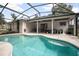 Beautiful screened-in pool with a covered patio area, perfect for outdoor entertainment and relaxation at 613 John Thomas Ave, Deland, FL 32724