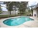 Private kidney-shaped pool surrounded by a screened enclosure and concrete deck at 613 John Thomas Ave, Deland, FL 32724