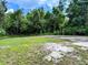 Spacious backyard with lush greenery and mature trees, perfect for outdoor activities at 632 W Hubbard Ave, Deland, FL 32720