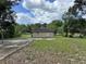 Rear view of the home surrounded by a grassy yard and mature trees at 632 W Hubbard Ave, Deland, FL 32720