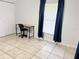 Bedroom with tile floors, closet, lots of natural light, and desk at 632 W Hubbard Ave, Deland, FL 32720