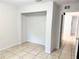 Bright bedroom showcasing a built-in closet space with ceramic tile floors at 632 W Hubbard Ave, Deland, FL 32720