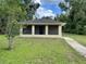 Single story home with neutral toned paint and green lawn and walkway at 632 W Hubbard Ave, Deland, FL 32720