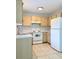 Functional kitchen features white appliances, light wood cabinets, and tile floors at 632 W Hubbard Ave, Deland, FL 32720
