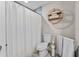Well decorated bathroom features a shower and a decorative towel rack and shelving at 64 Ravenwood Ct, Ormond Beach, FL 32174