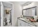 Elegant bathroom featuring granite countertop, modern fixtures and tiled floors at 64 Ravenwood Ct, Ormond Beach, FL 32174