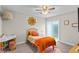 Cozy bedroom is well lit with a sliding glass door and features a decorative rug and light fixture at 64 Ravenwood Ct, Ormond Beach, FL 32174
