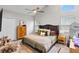 Cozy bedroom boasts vaulted ceiling, plush bedding, and charming decor at 64 Ravenwood Ct, Ormond Beach, FL 32174