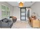 Inviting office space with lots of natural light, featuring a sliding barn door and stylish decor at 64 Ravenwood Ct, Ormond Beach, FL 32174