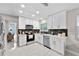 Bright kitchen features white cabinets, stainless steel appliances, and sleek countertops at 64 Ravenwood Ct, Ormond Beach, FL 32174