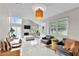 Open-concept living room with sleek tiled floors, contemporary lighting, fireplace, and comfortable seating at 64 Ravenwood Ct, Ormond Beach, FL 32174