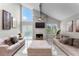 Spacious living room features vaulted ceilings, modern fireplace, and stylish neutral decor at 64 Ravenwood Ct, Ormond Beach, FL 32174