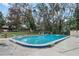 This in-ground community swimming pool is surrounded by fencing and lounge chairs at 64 Ravenwood Ct, Ormond Beach, FL 32174