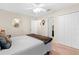 Neutral bedroom with a ceiling fan, closet, and en-suite bathroom access at 727 Grape Ivy Ln, New Smyrna Beach, FL 32168