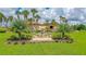 This depicts the Sugar Mill Country Club sign surrounded by palm trees and landscaping at 727 Grape Ivy Ln, New Smyrna Beach, FL 32168