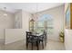 A dining room boasts a chandelier and large window allowing ample natural light at 727 Grape Ivy Ln, New Smyrna Beach, FL 32168
