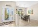 Dining room with a modern table set, a large window, and chandelier lighting at 727 Grape Ivy Ln, New Smyrna Beach, FL 32168