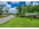 The Sugar Mill community entrance features lush landscaping, mature trees, and security features at the guard house at 727 Grape Ivy Ln, New Smyrna Beach, FL 32168