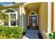 Close up of the front door to the house with small plants and nice landscaping at 727 Grape Ivy Ln, New Smyrna Beach, FL 32168