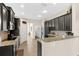 Modern kitchen with granite countertops, stainless steel appliances, and dark cabinetry at 727 Grape Ivy Ln, New Smyrna Beach, FL 32168