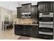 A kitchen with stainless-steel double oven and microwave with eat in breakfast area at 727 Grape Ivy Ln, New Smyrna Beach, FL 32168