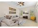 Comfortable living room featuring plush seating, a ceiling fan, and plenty of natural light at 727 Grape Ivy Ln, New Smyrna Beach, FL 32168