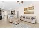 Comfortable living room featuring tile floors, neutral paint, stylish decor, and an open concept kitchen view at 727 Grape Ivy Ln, New Smyrna Beach, FL 32168