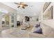 Spacious living room with tile flooring and an open layout leading to a kitchen at 727 Grape Ivy Ln, New Smyrna Beach, FL 32168