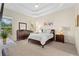Spacious main bedroom with a tray ceiling, plush carpeting, and plenty of natural light at 727 Grape Ivy Ln, New Smyrna Beach, FL 32168