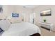 Bright main bedroom with a ceiling fan, TV, and en-suite bathroom access at 727 Grape Ivy Ln, New Smyrna Beach, FL 32168