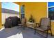 Close up of covered patio with outdoor seating and grill with plants at 727 Grape Ivy Ln, New Smyrna Beach, FL 32168