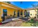 Covered patio with outdoor seating, grill, and view of the backyard at 727 Grape Ivy Ln, New Smyrna Beach, FL 32168