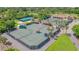 Aerial view of well-maintained tennis courts surrounded by lush greenery and palm trees at a recreational facility at 727 Grape Ivy Ln, New Smyrna Beach, FL 32168