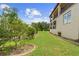 Scenic backyard featuring lush greenery, a manicured lawn, and a view of the home's balconies at 762 Onyx Pkwy, Deland, FL 32724